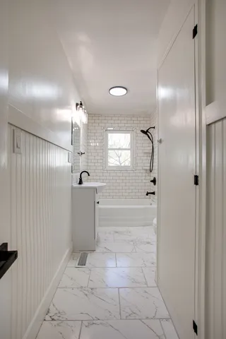a bathroom with a shower and a sink