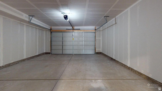 783 Pheasantbrook Drive, Unit 2A Centerville, UT 84014 - Photo 38 of 41 Spacious two-car garage featuring a sectional overhead door, concrete flooring, and an automatic garage door opener
