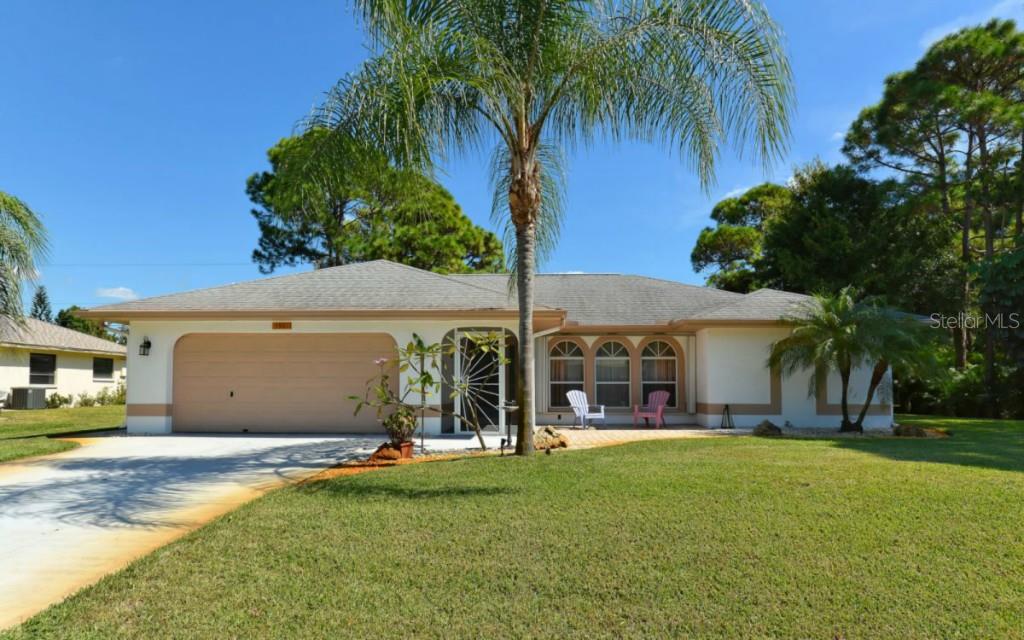 5981 Regent Road Venice, FL 34293 - Photo 1 of 1 a view of a house with a backyard and a tree