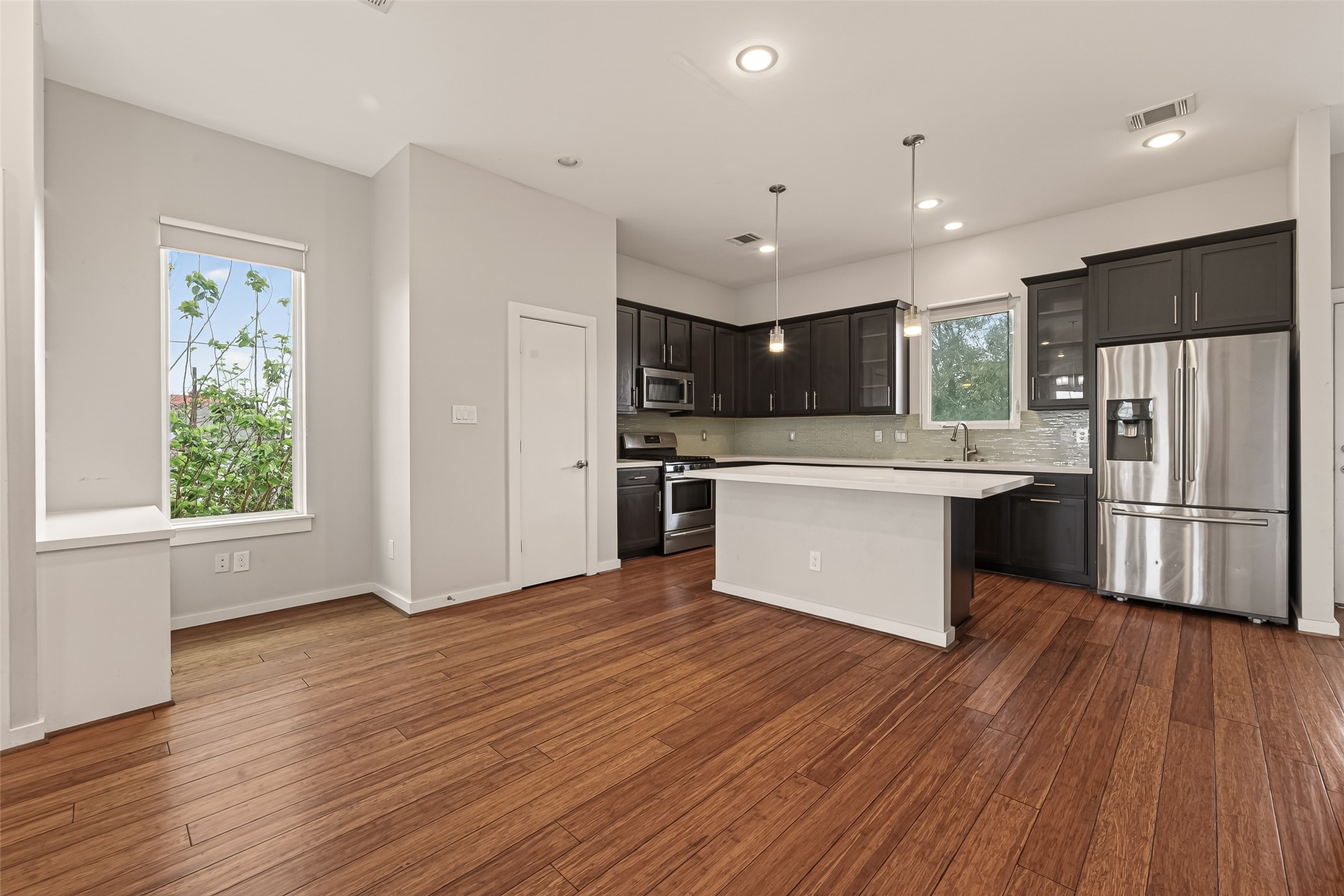 1819 South Street Houston, TX 77009 - Photo 8 of 27 a kitchen with stainless steel appliances wooden floor sink and wooden cabinets