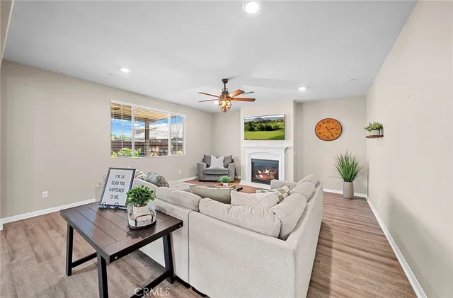a kitchen with stainless steel appliances a dining table chairs stove and refrigerator