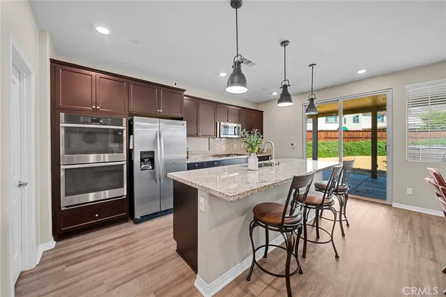 a dining room with furniture and wooden floor
