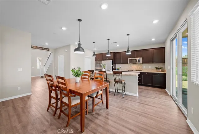 a living room with furniture a fireplace and a window