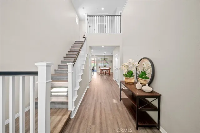 a kitchen with stainless steel appliances granite countertop a stove a refrigerator a microwave oven with a dining table and chairs