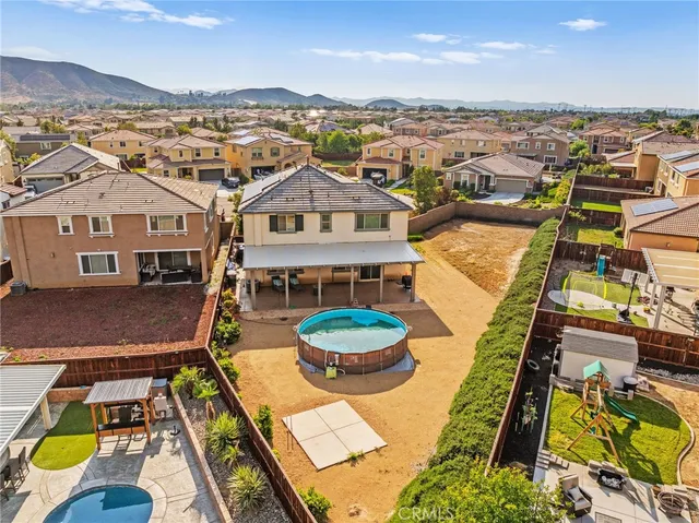 a view of a house with a yard and potted plants