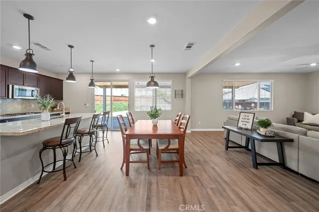 a dining room with furniture window and wooden floor