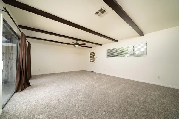 a view of a big room with closet and windows