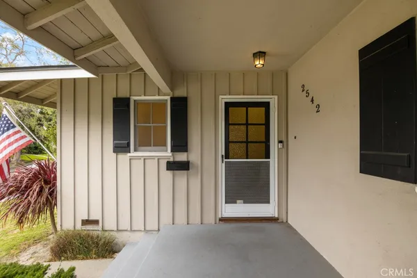a view of a hallway with wooden walls and windows