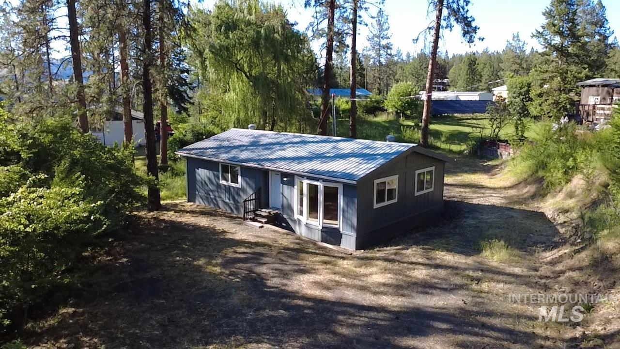 151 View Road Kamiah, ID 83536 - Photo 38 of 49 Single-story residence featuring a gray exterior siding, white window trim, and a corrugated metal roof