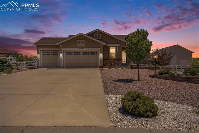 9709 Rockingham Drive Peyton, CO 80831 - Photo 5 of 50 View of front facade with stucco siding, a garage, concrete driveway, and fence