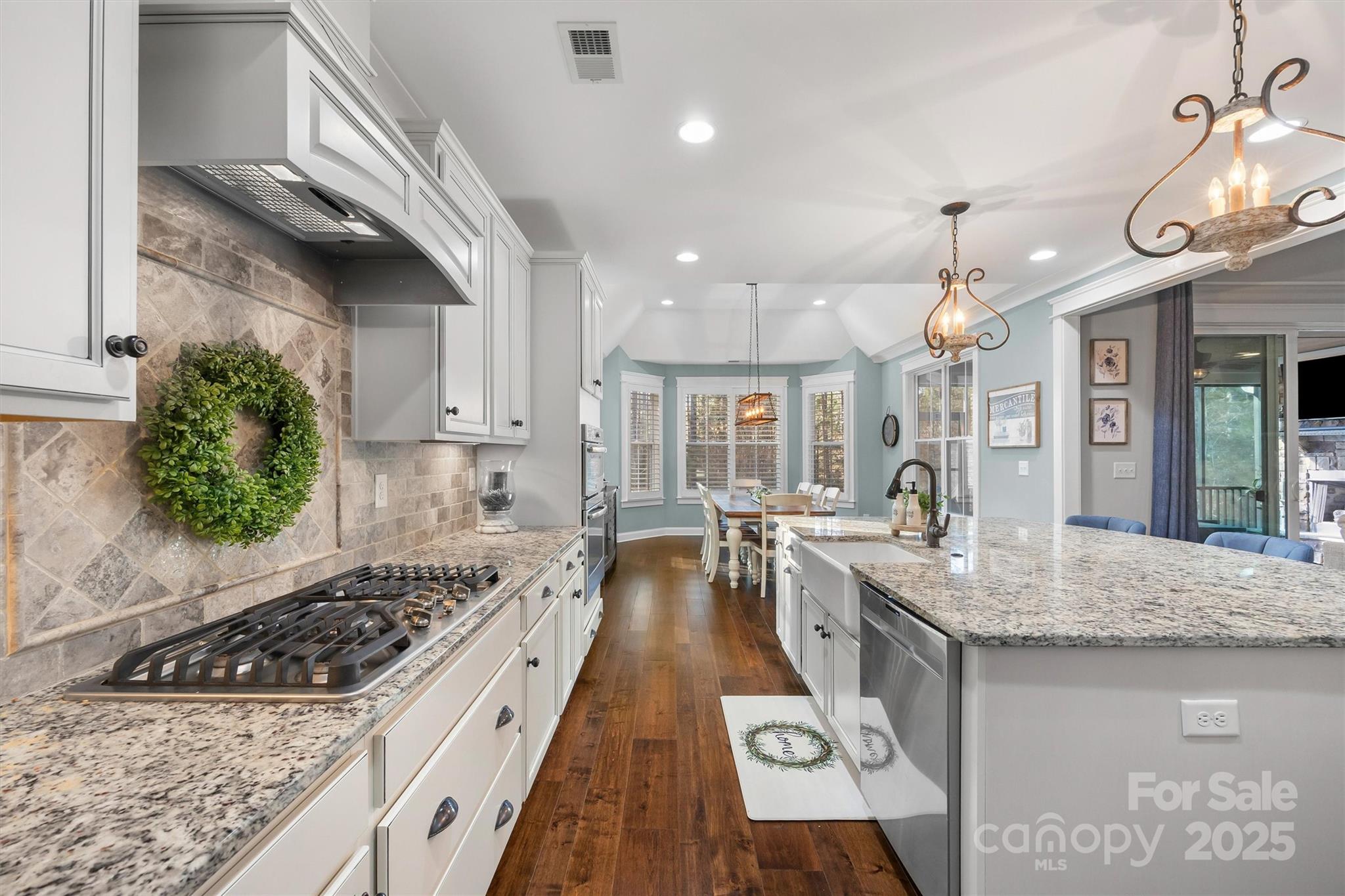 4221 Persimmon Road Lancaster, SC 29720 - Photo 12 of 48 a kitchen with granite countertop a stove a sink a counter space and dining table