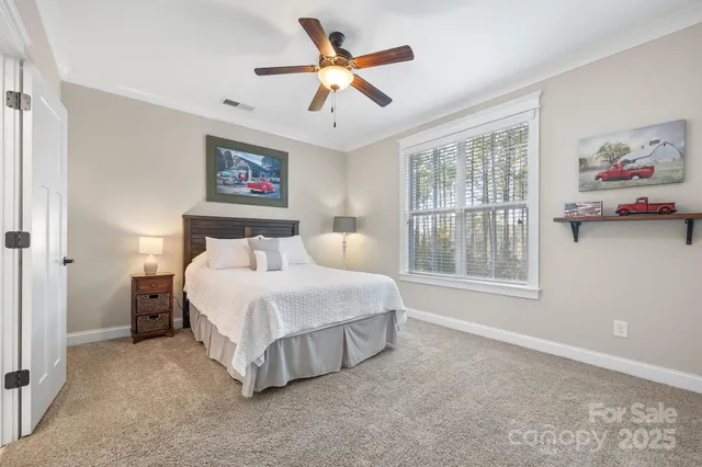 a spacious bedroom with a bed and a window