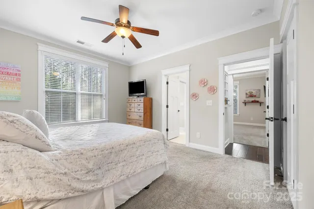 a spacious bedroom with a large bed closet and window