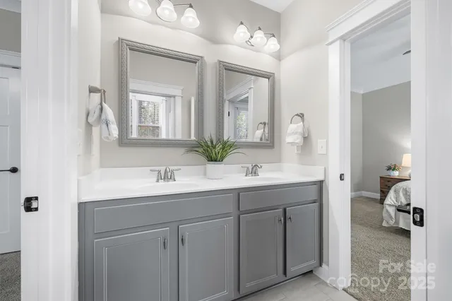 a bathroom with a sink double vanity and a mirror