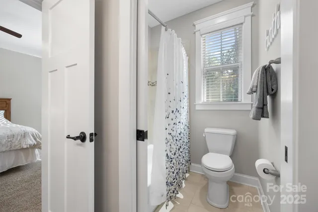 a white toilet sitting next to a bathroom sink