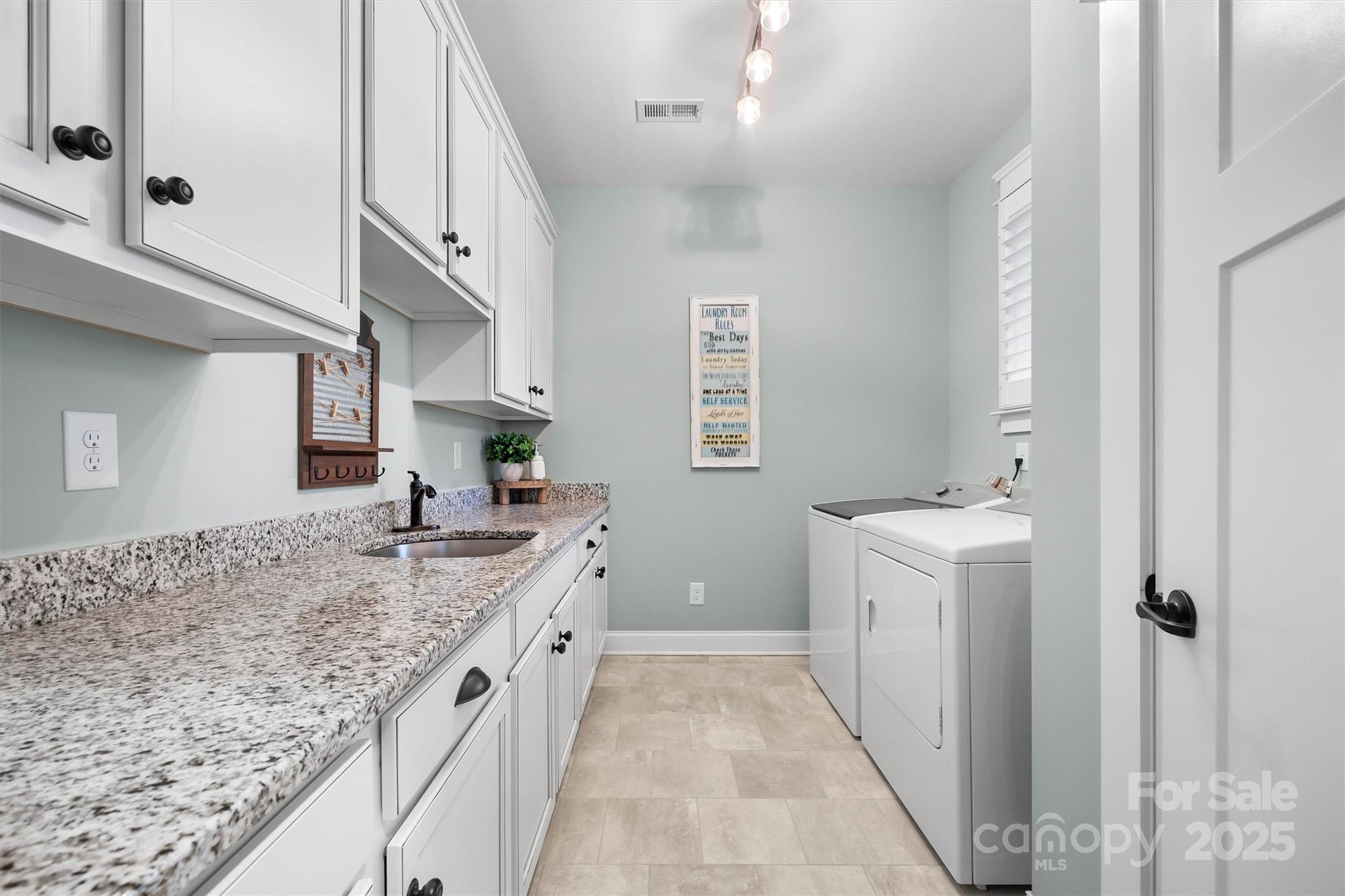 4221 Persimmon Road Lancaster, SC 29720 - Photo 21 of 48 a spacious bathroom with a granite countertop sink and a washing machine