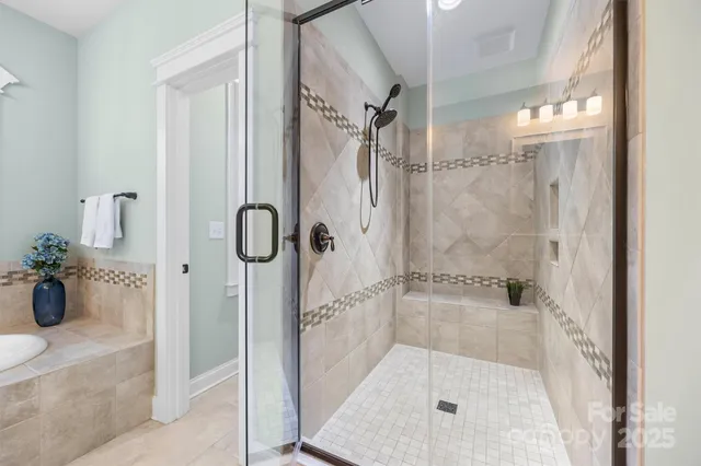 a bathroom with a glass shower door