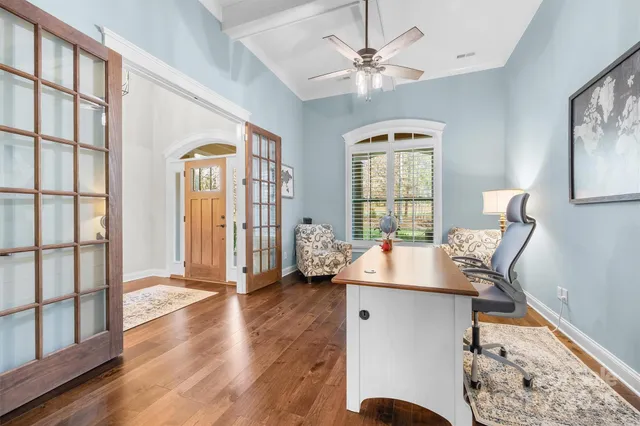 a view of a workspace with furniture and a window