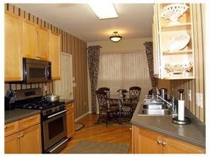 2 Mioduski Court Parlin, NJ 08859 - Photo 7 of 10 a kitchen with stainless steel appliances granite countertop a stove and a sink