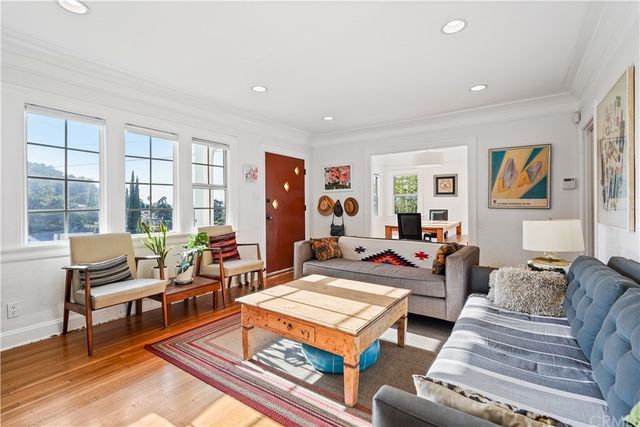 a living room with furniture a rug and a large window