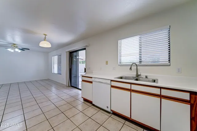 a kitchen with a sink cabinets and window