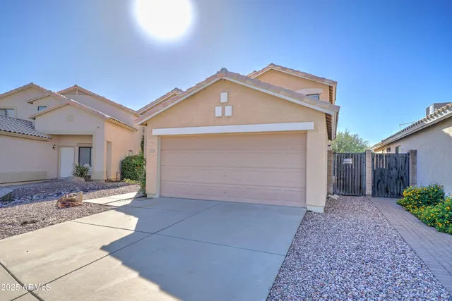 a view of a house with a yard and garage