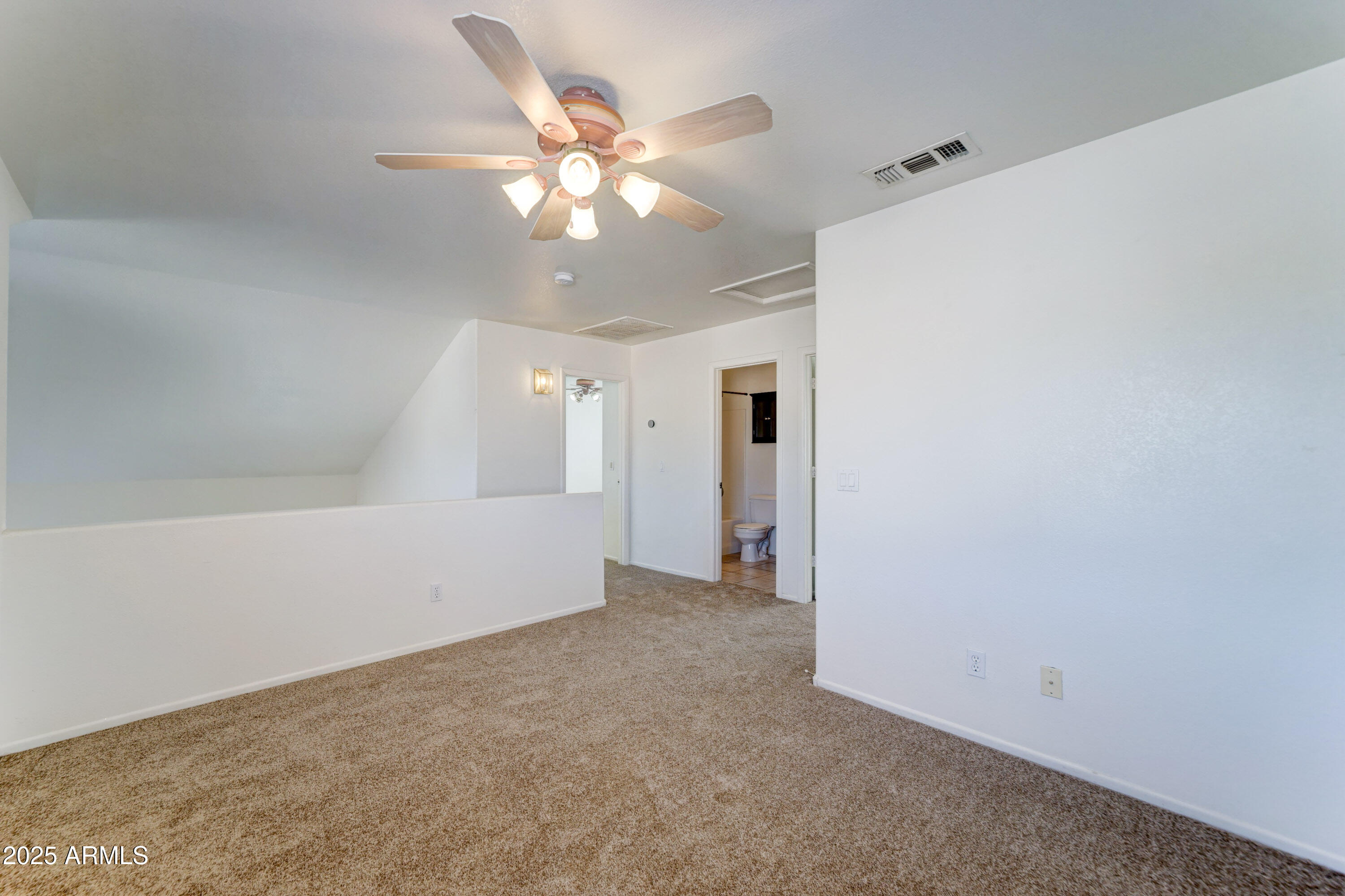 Undisclosed Address Phoenix, AZ 85024 - Photo 24 of 32 an empty room with a chandelier fan and closet area