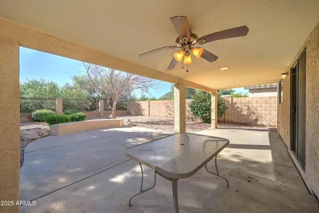 a view of a porch with furniture and a yard
