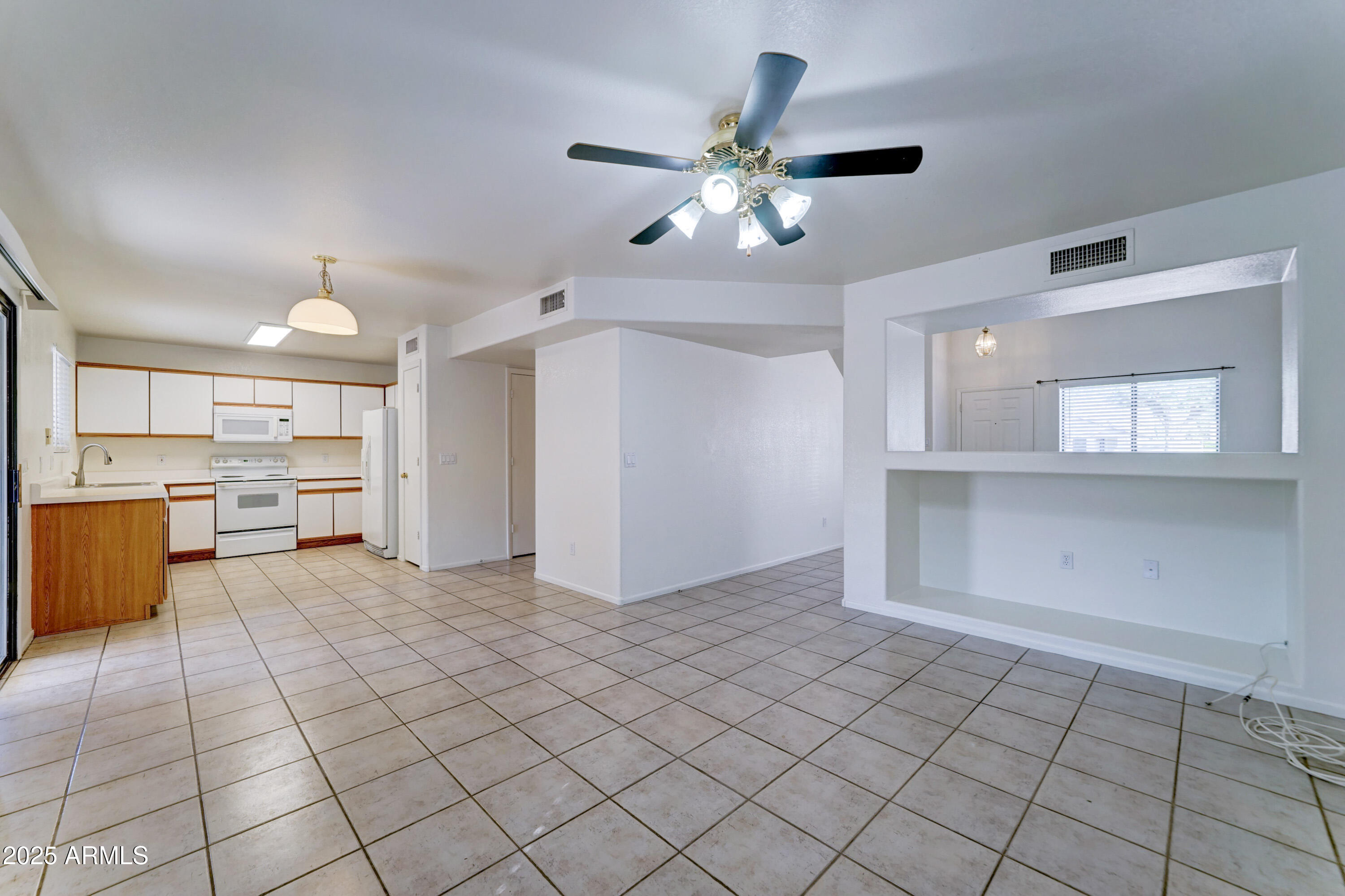 Undisclosed Address Phoenix, AZ 85024 - Photo 10 of 32 a view of an empty room with a kitchen