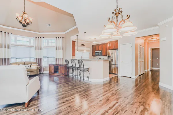 a living room with kitchen island furniture and a wooden floor