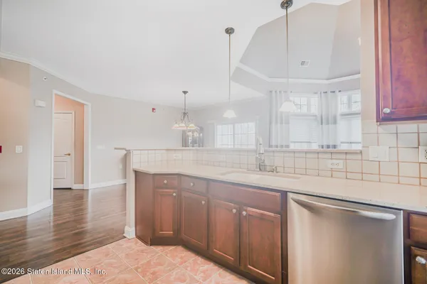 a kitchen with granite countertop a sink a toilet and cabinets