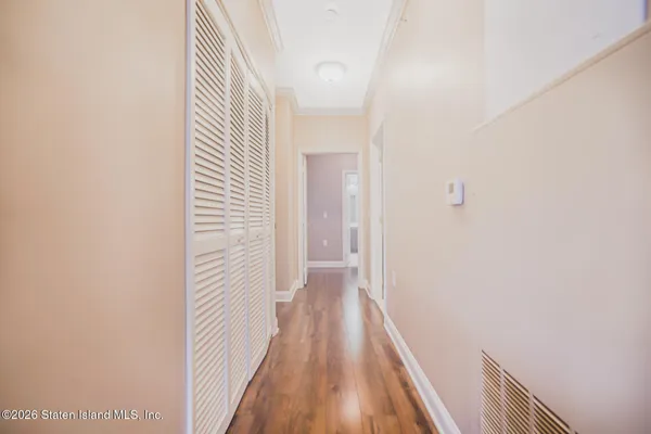 a view of a hallway with wooden floor