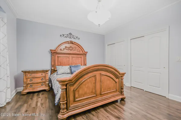 a living room with furniture a bed and a chandelier