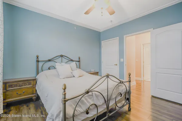 a bedroom with a bed and wooden floor