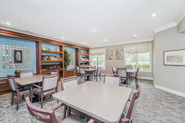 a living room with furniture a rug and a large window