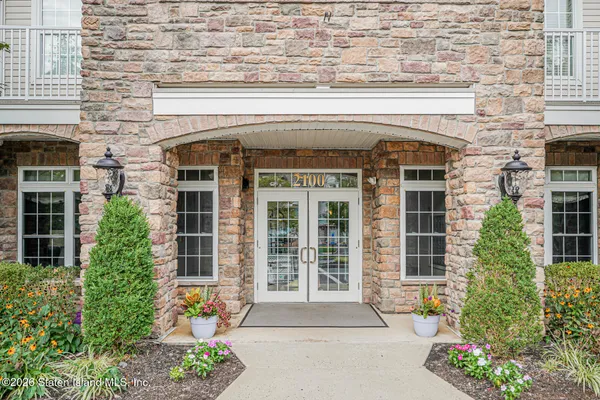 a front view of a house with a potted plant and windows