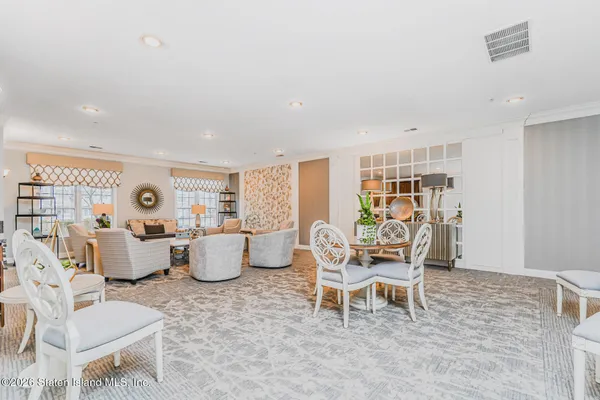 a living room with patio furniture and a wooden floor