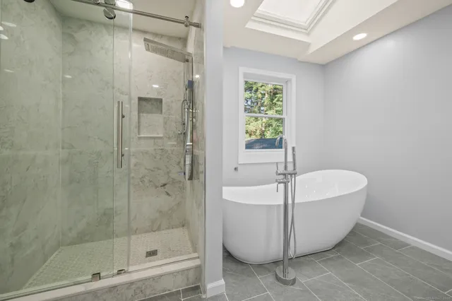 a bathroom with a bathtub and shower