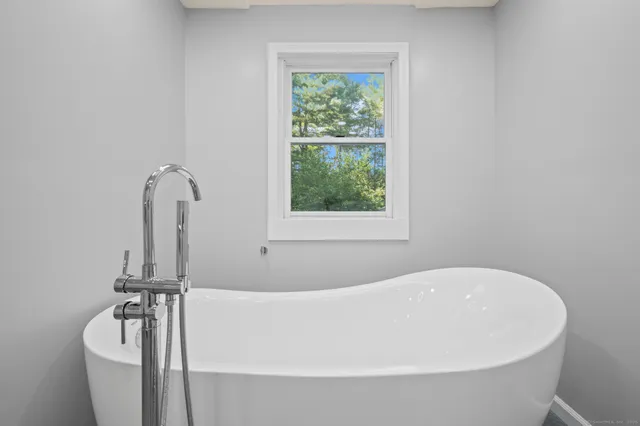 a white bath tub sitting next to a window