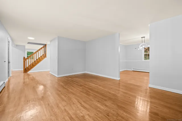 a view of an empty room and wooden floor