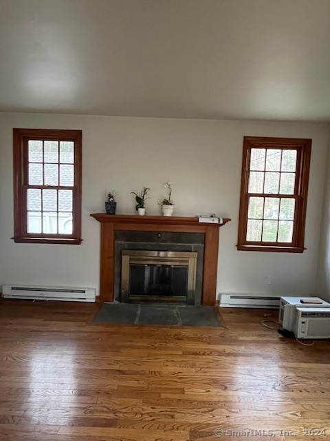 West Mountain Road Ridgefield, CT 06877 - Photo 3 of 17 an empty room with windows fireplace and wooden floor