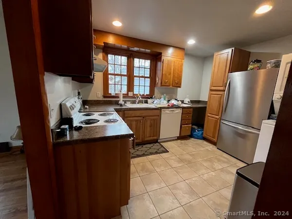 a kitchen with a stove a refrigerator and a refrigerator