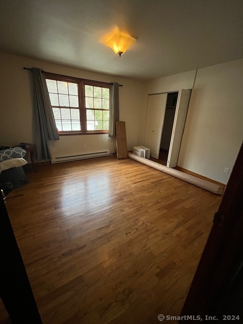 West Mountain Road Ridgefield, CT 06877 - Photo 8 of 17 an empty room with wooden floor and windows
