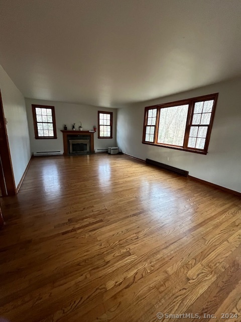 West Mountain Road Ridgefield, CT 06877 - Photo 9 of 17 a view of a livingroom with wooden floor and a fireplace