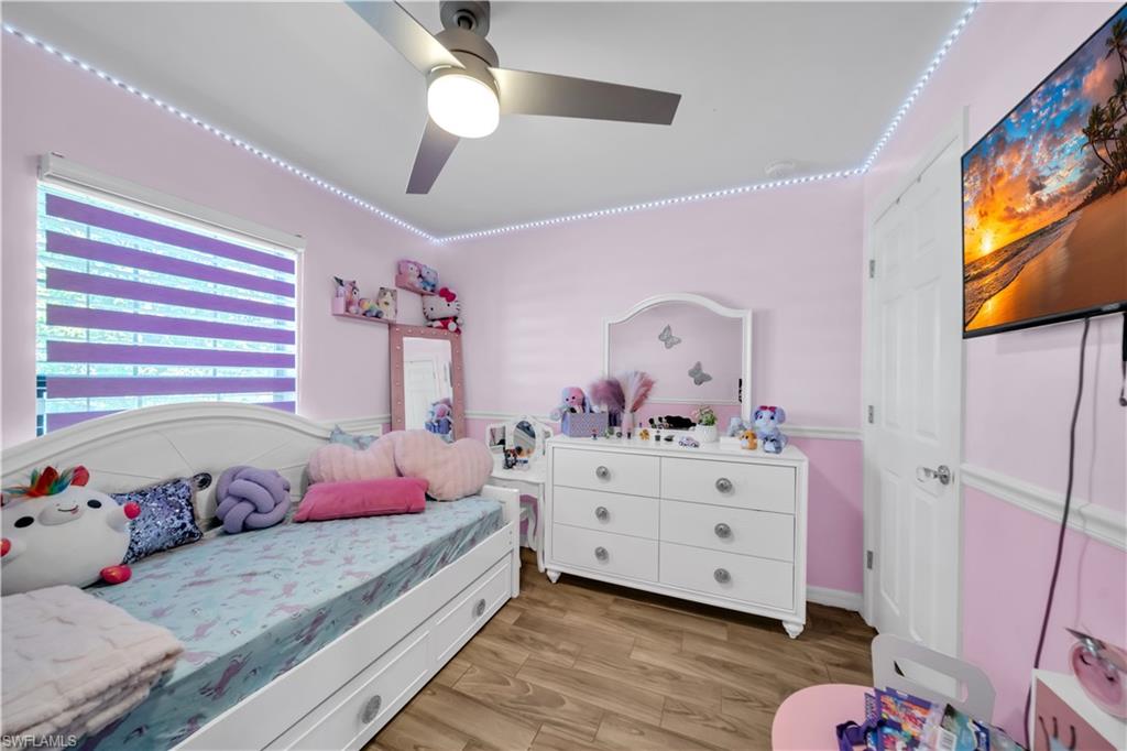175 Shadowview Court Lehigh Acres, FL 33974 - Photo 26 of 39 a bedroom with a bed and a dresser