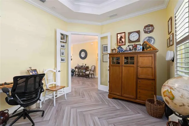 a bedroom with a bed and a flat tv screen on dresser