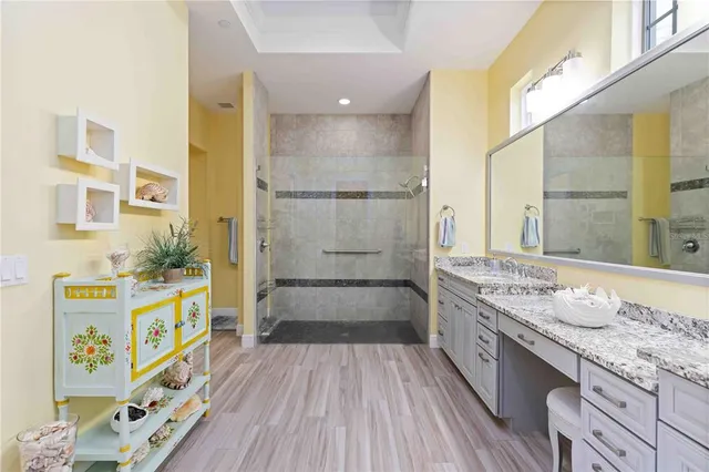 a bathroom with a granite countertop sink and a toilet