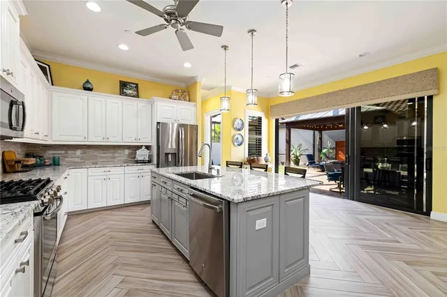 a kitchen with a sink stove top oven and refrigerator