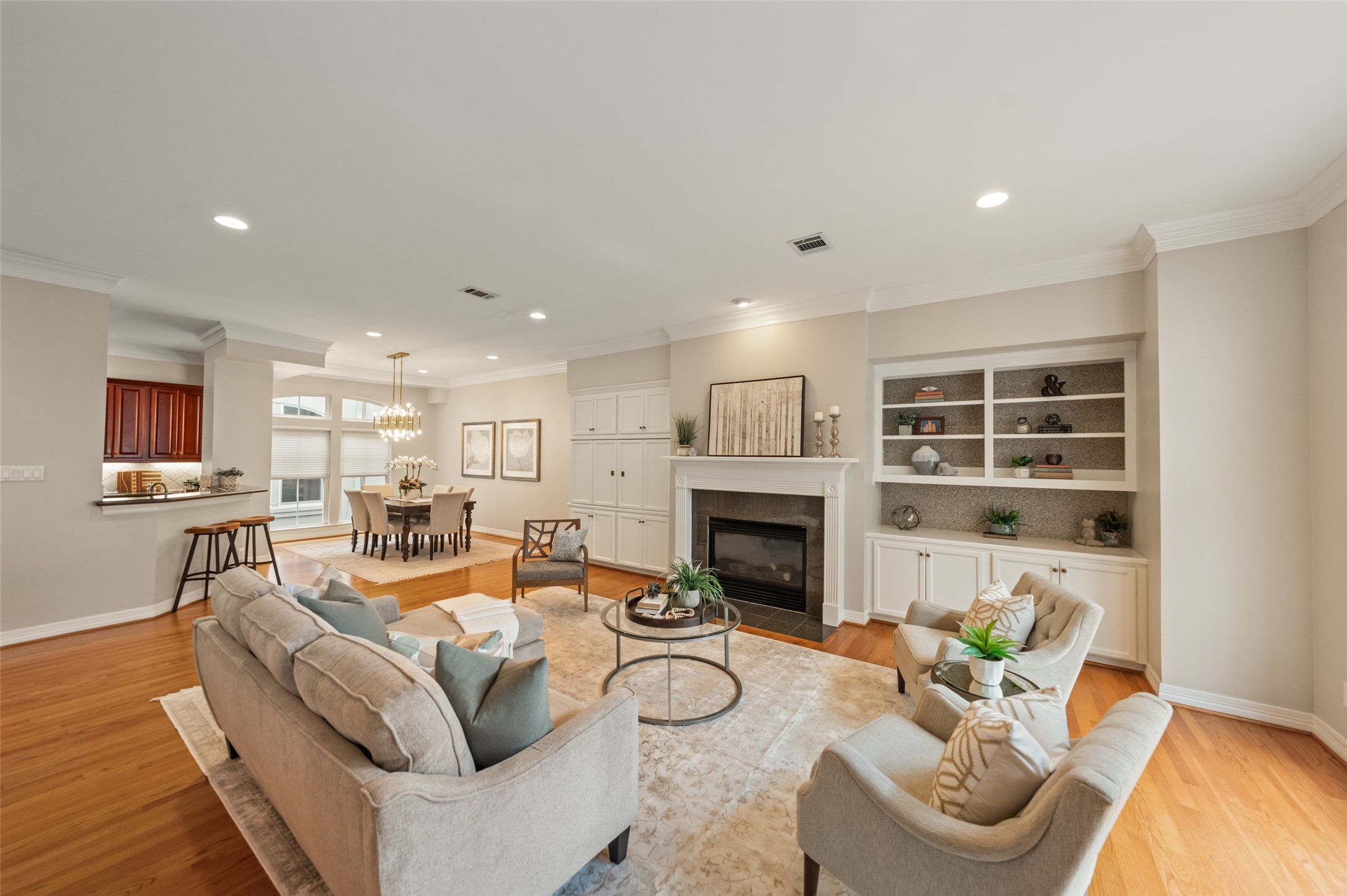 2708 Wroxton Road West University Place, TX 77005 - Photo 21 of 22 Experience seamless entertaining in this open floor plan, highlighted by a cozy gas fireplace and ample built-in storage.