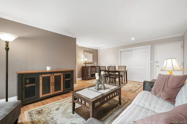 a living room with furniture a table and kitchen view